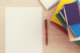Books paper and pen on a desk