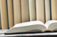 Dictionary open on a desk, viewed from the side