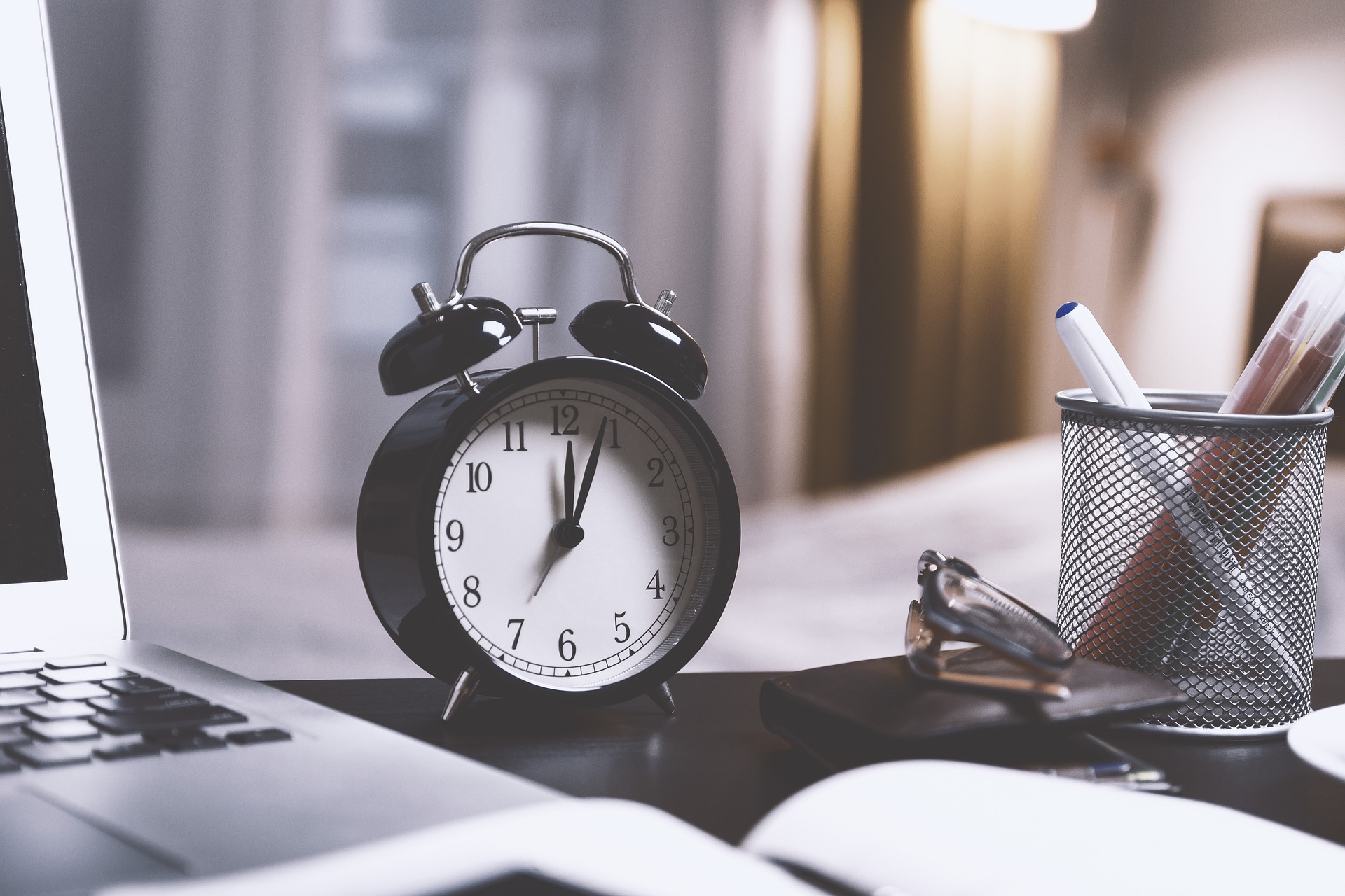 Alarm clock and papers on desk
